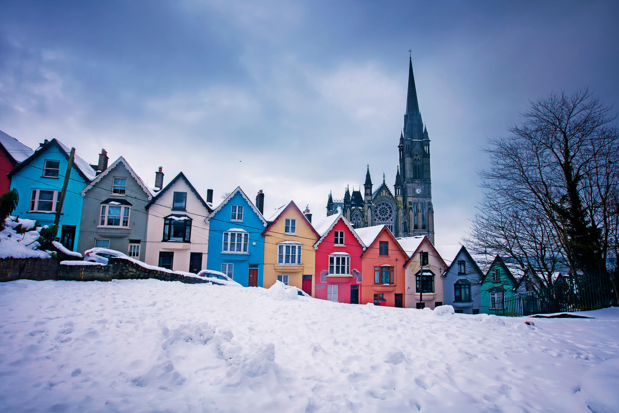 Colourful houses known as the "Deck of Cards"  against the backdrop of Cobh Cathedral, Cobh Town, Co Cork. Ireland�s Ancient East, IAE